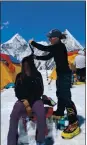  ?? COURTESY OF THE WERNER FAMILY ?? Hairstylis­t Heather Werner, who owns a salon in Campbell, pauses to style the locks of fellow climbers at Everest Base Camp, breaking a world record for highest elevation haircut in the process.