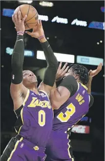  ?? Marcio Jose Sanchez Associated Press ?? RUSSELL WESTBROOK grabs a rebound next to Anthony Davis in the first half. Westbrook had 15 points and 11 rebounds.