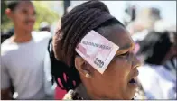  ?? PICTURE EPA ?? SURVIVAL: A protester wears a fake R200 note in her headdress with the words ‘National Minimum Wage’ printed on it during a Cosatu protest.