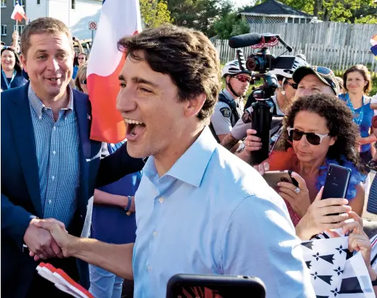  ??  ?? Prime Minister Trudeau and Conservati­ve Leader Scheer shake hands in Dieppe, N.B.