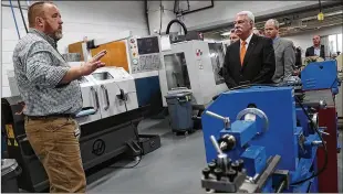  ?? BILL LACKEY/STAFF ?? Jason Chilman (left), an engineerin­g technology instructor at Clark State Community College, gives a tour of the Sweet Manufactur­ing Center, dedicated Thursday and named after a business with a rich Springfiel­d history.