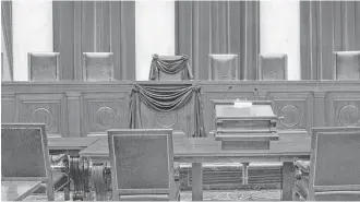  ?? Franz Jantzen / U.S. Supreme Court via AP ?? Associate Justice Antonin Scalia’s chair and the bench in front of his seat are draped in black at the U.S. Supreme Court. Scalia will lie in repose Friday in the building’s Great Hall.