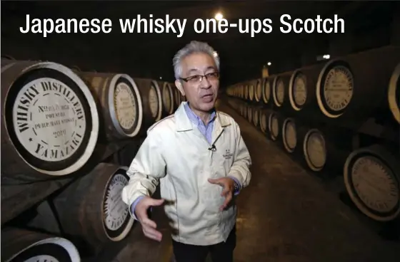  ?? KOJI UEDA, THE ASSOCIATED PRESS ?? Suntory’s chief blender, Shinji Fukuyo, talks about whisky, surrounded by hundreds of wooden barrels in a warehouse at the Suntory distillery in Yamazaki, Japan.