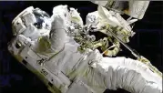  ?? NASA VIA ASSOCIATED PRESS ?? Astronaut Joe Acaba performs a spacewalk outside the Internatio­nal Space Station on Friday. Acaba was barely outside an hour when he had to replace one of his safety tethers that was frayed and worn.