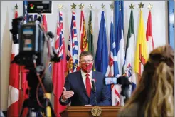  ?? CP PHOTO MICHAEL BELL ?? Premier Scott Moe speaks to media after the announceme­nt of his new cabinet at Government House in Regina on Monday. The size of the cabinet remained the same at 18 MLAs.