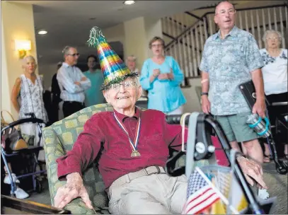  ?? Rachel Aston ?? Las Vegas Review-journal @rookie__rae Family and friends sing happy birthday Thursday to Gene Stephens at the Atria Seville assisted-living facility in Las Vegas. Stephens, who turns 100 Friday, is the last surviving member of the original Military Police Corps, which was created in 1941.