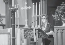  ?? Mark Mulligan / Houston Chronicle ?? Harris County District Attorney Kim Ogg reads from the Book of Isaiah during a memorial service for her father, Jack.