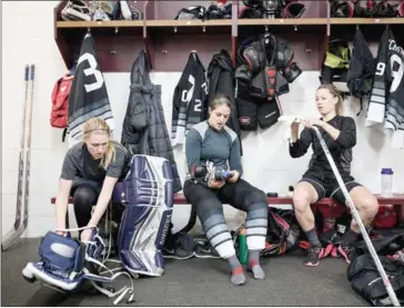  ?? TIM GRUBER/THE NEW YORK TIMES ?? From left, Minnesota Whitecaps’ Lindsey Brown, Kalli Funk and Haylea Schmid get ready before their scrimmage at Ridder Arena in Minneapoli­s on January 6.