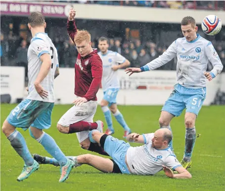  ??  ?? Forfar’s Kevin Nicoll, grounded, tackles Linlithgow’s new signing Connor Kelly.
