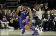  ?? MATT SLOCUM — THE ASSOCIATED PRESS ?? Sixers center Joel Embiid, left, and San Antonio Spurs’ Brandon Paul chase after a loose ball during the second half Wednesday.