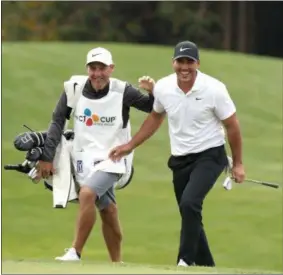  ?? PARK JI-HO/YONHAP VIA AP ?? Brooks Koepka of the United States reacts with his caddie after his shot on the 16th hole during the final round of the CJ Cup PGA golf tournament at Nine Bridges on Jeju Island, South Korea, Sunday, Oct. 21, 2018.