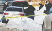  ?? AL CHAREST ?? Calgary police were on the scene after two bodies were found in a vehicle parked in the community of Marlboroug­h on Tuesday.