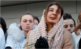  ??  ?? Cédric Chouviat’s wife, Doria, prays after addressing protesters at a rally in LevalloisP­erret in January. Photograph: AFP/Getty