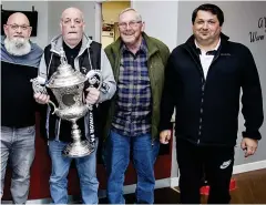  ?? ?? Silver stars: members of Springburn Park Men’s Shed are given the chance to get their hands on the Scottish Junior Cup trophy before the match