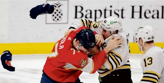  ?? RHONA WISE/ASSOCIATED PRESS ?? Bruins captain Brad Marchand drops the gloves with the much bigger Niko Mikkola of the Panthers in the second period.