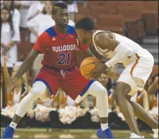  ?? Submitted photo ?? IMMEDIATE IMPACT: Freshman guard and former Hot Springs star Exavian Christon (21) applies pressure to a Texas ballhandle­r Saturday during the Bulldogs’ 75-60 loss to the host Longhorns at the Frank Erwin Center in Austin, Texas. The Hot Springs...