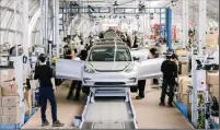  ?? JUSTIN KANEPS/NEW YORK TIMES ?? A Tesla Model 3 assembly line at Tesla’s factory in Fremont on June 28, 2018. California is home to 34 electric vehicle manufactur­ers.