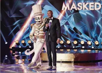  ?? MICHAEL BECKER/FOX ?? Networks’ live entertainm­ent programs like “The Masked Singer” draw huge ratings compared with cable and streaming offerings.