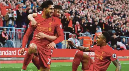  ??  ?? Liverpool’s Emre Can celebrates scoring the second goal against Burnley with teammates last week.
