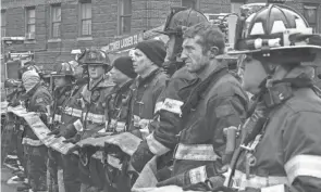  ?? ?? Firefighte­rs help at an apartment building in the Bronx, N.Y., that caught fire Sunday. Many victims suffered from severe smoke inhalation, says FDNY Commission­er Daniel Nigro.