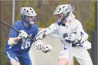  ?? Dave Stewart / Hearst Connecticu­t Media ?? Darien’s Brady Pokorny (99) battles Glastonbur­y’s Ryder Harmon (16) during a game in April.