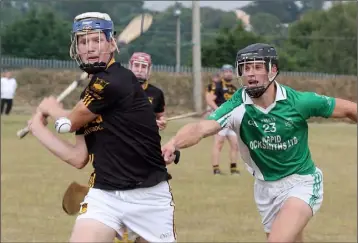  ??  ?? Liam Stafford (Adamstown) strikes despite the best efforts of Ronan Devereux (Crossabeg-Ballymurn).