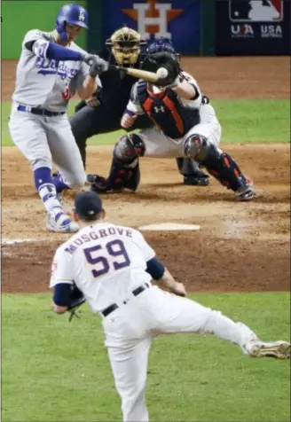  ?? CHARLIE RIEDEL — THE ASSOCIATED PRESS ?? Los Angeles Dodgers’ Joc Pederson hits a three-run home run off Houston Astros relief pitcher Joe Musgrove during the ninth inning of Game 4 of baseball’s World Series Saturday in Houston.