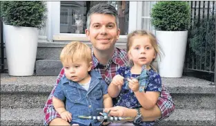  ?? SUBMITTED PHOTO ?? Jarrod Pettipas of Fall River, N.S., sits on the front step of his home with his daughter Kennedy, 2, and son Owen, 1.