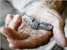  ?? RICHARD GRAULICH / THE PALM BEACH POST ?? Edward Sicard holds his Air Force pilot wings. The veteran gets emotional sometimes when he thinks back on the war.