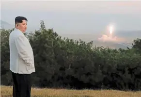  ?? ?? Hit from all sides: North Korean leader Kim Jong-un inspecting a missile test at an undisclose­d location in North Korea, in this photo taken sometime between Sept 25 and Oct 9. — AP