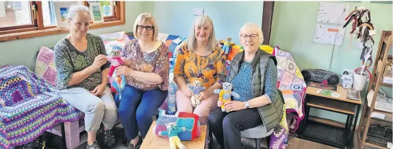  ?? ?? Act of kindness Jen Anderson from the Scottish Refugee Council, Blairgowri­e SWI Group president Edith Christie, local group secretary Christine Fleming and Muriel Brown, a former president of the group