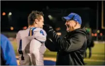  ?? NATE HECKENBERG­ER — FOR DIGITAL FIRST MEDIA ?? Downingtow­n West coach Mike Milano shares a moment with Ryan Wetzel after Friday night’s game against North Penn.