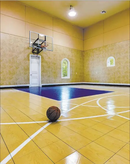  ?? COURTESY OF LUXURY ESTATES INTERNATIO­NAL ?? Owners of the home at 9511 Kings Gate Court, Gary and Connie Tharaldson, and their children have hosted all sorts of school events at on their basketball court.