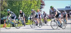  ?? LAWRENCE POWELL ?? The first group of cyclists pulls on to St. George Street in Annapolis Royal for the start of the Annapolis County Road Race. These cyclists were racing to Middleton and then back to Annapolis Royal – a distance of 93 kilometres. Tops racers made it in...
