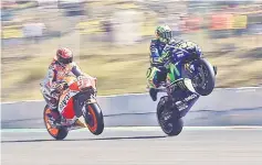  ??  ?? Repsol Honda Team’s Spanish rider Marc Marquez (left) and Movistar Yamaha MotoGP Italian rider Valentino Rossi make wheelies during the qualificat­ion of the Moto GP Grand Prix of the Czech Republic in Brno. — AFP photo