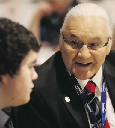  ??  ?? Winston Wuttunee, 2013 Indspire award recipient for culture, heritage and spirituali­ty,
speaks to one of the youth Suncor hosted at the 2014 Indspire awards.