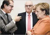  ?? CLEMENS BILAN/EPA ?? German Chancellor Angela Merkel talks Monday with Alexander Dobrindt, left, of the Christian Social Union.