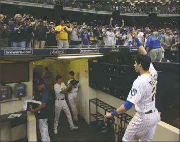  ?? The Associated Press ?? VICTORY WALK: Fans cheer as Milwaukee Brewers’ Christian Yelich walks off the field after driving in the winning run with a double during the ninth inning of the team’s Sept. 7, 2019, baseball game against the Chicago Cubs in Milwaukee. Major League Baseball will start each extra inning this season by putting a runner on second base. This rule has been used since 2018 in the minor leagues, where it created more action and settled games sooner. “I think it’s great,” Yelich said. “As a player, there’s nothing worse than extra innings.”