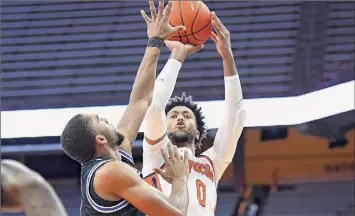  ?? Rich Barnes / USA TODAY Sports ?? Syracuse forward Alan Griffin, shooting over Buffalo’s Jayvon Graves, had a key block to force overtime against the contentiou­s Bulls. The Orange erased a 16-point deficit in the win.