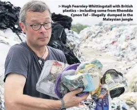  ??  ?? > Hugh Fearnley-Whittingst­all with British plastics – including some from Rhondda Cynon Taf – illegally dumped in the Malaysian jungle