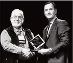  ?? Submitted photo ?? Hans-Henning Muendel, left, receives the Alberta Pulse Industry Innovator Award from D’Arcy Hilgartner, president of the Alberta Pulse Growers Commission, Wednesday in Edmonton.