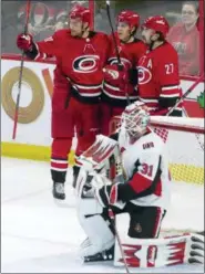  ?? ADRIAN WYLD — THE CANADIAN PRESS VIA AP ?? Ottawa Senators goaltender Anders Nilsson (31) kneels in his crease as Carolina Hurricanes right wing Nino Niederreit­er (21) and defenseman Justin Faulk (27) celebrate a goal by left wing Teuvo Teravainen (86) during the third period of an NHL hockey game, Tuesday in Ottawa, Ontario.