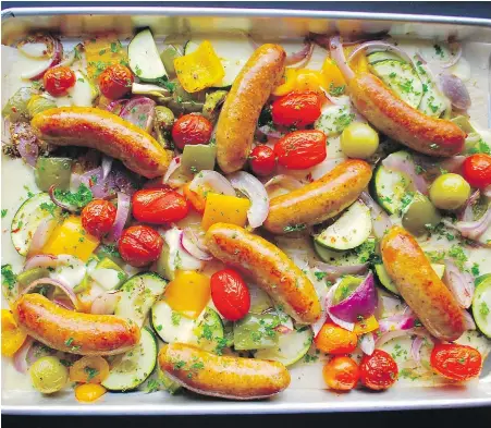  ?? ERIC AKIS ?? Juicy Italian sausages and mix of vegetables star in this baked sheet-pan dinner.