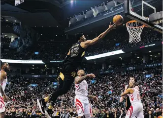  ?? CHRISTOPHE­R KATSAROV/THE CANADIAN PRESS ?? Toronto Raptors forward Malcolm Miller goes for a layup during a first half that saw Toronto build a big lead over the visiting Houston Rockets in Friday’s 108-105 victory.