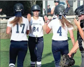  ??  ?? Gordon Lee’s Katherine Grace McElhaney gives a double high-five to Paxton Grimes (left) and Gracey Kruse (right) after both runners scored during a victory over Trion on Thursday. (Photo by Scott Herpst)