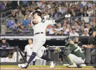  ?? Bill Kostroun / Associated Press ?? The Yankees’ Aaron Judge follows through on a two-run home run against the Athletics during their American League wild-card game Oct. 3.