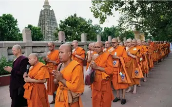  ?? — PTI ?? More than 120 Thai immigratio­n officers from Thailand offer prayer for the salvation of Late King Bhumibol Adulyadeja­t Bodhgaya on Saturday.