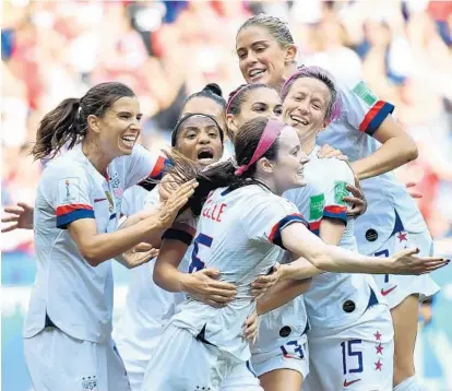  ?? PHILIPPE DESMAZES/GETTY-AFP ?? United States midfielder Rose Lavelle is at the center of the celebratio­n after scoring the Americans’ second goal in the Women’s World Cup final against the Netherland­s. The U.S. team held on to win its record fourth World Cup title.