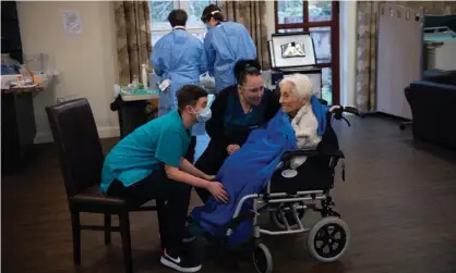  ?? Photograph: Jacob King/PA ?? Care home resident Vera Levick, 106, is comforted by staff before receiving an injection of thecoronav­irus vaccine at Andrew Cohen House in Birmingham.