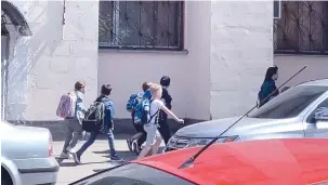  ?? (Reuters) ?? CHILDREN RUN AFTER hearing an explosion in Kyiv, yesterday, in this screengrab obtained from social media video.